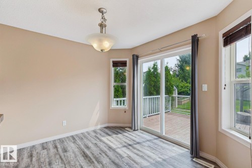 Room featuring wood-finish flooring, neutral wall tones, and a contemporary ceiling light fixture - 16765 119 Street Nw, Edmonton, AB - Indoor Photo Showing Other Room