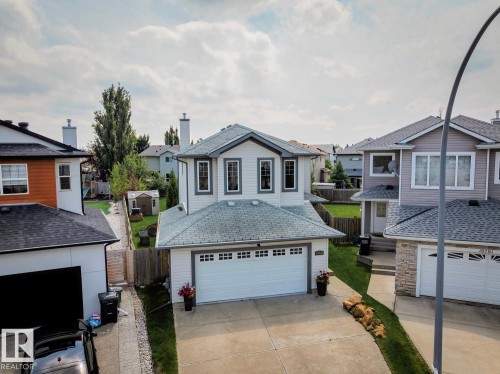 Two-story residence featuring white siding and gray trim - 16765 119 Street Nw, Edmonton, AB - Outdoor