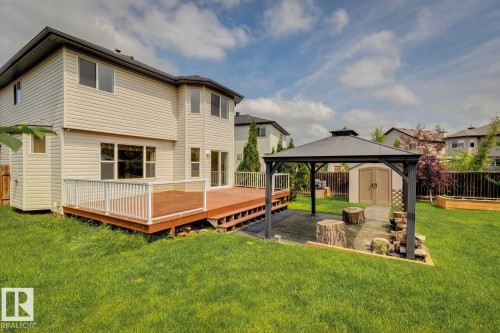 Expansive backyard featuring a multi-level deck with clear panel railing, a dedicated patio space with gazebo, and a storage shed - 16765 119 Street Nw, Edmonton, AB - Outdoor With Deck Patio Veranda With Exterior