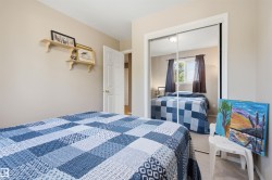 Room featuring a mirrored closet, light neutral wall paint, and light-colored carpeting - 