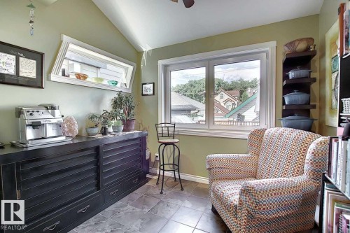 This room features warm green walls and tiled flooring - 11126 52 Street Nw, Edmonton, AB - Indoor