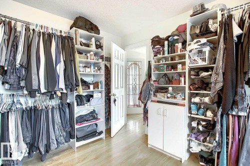 This property offers ample storage with built-in shelving and hanging rails - 11126 52 Street Nw, Edmonton, AB - Indoor With Storage