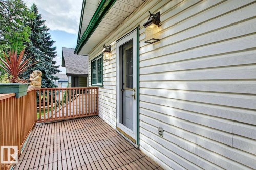The property features a private deck with wooden flooring and railings, a white exterior, and exterior lighting fixtures - 11126 52 Street Nw, Edmonton, AB - Outdoor With Deck Patio Veranda With Exterior