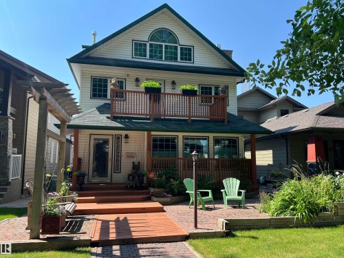 Three-story residence featuring light-colored siding and a dark green roof - 11126 52 Street Nw, Edmonton, AB - Outdoor With Deck Patio Veranda With Facade