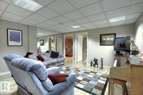 The interior features light-toned walls, a drop ceiling with integrated lighting, and light-colored flooring - 11126 52 Street Nw, Edmonton, AB - Indoor