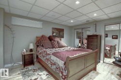 The room features light wood-style flooring and a drop ceiling with recessed lighting - 