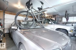 Spacious garage with overhead lighting and a white paneled garage door - 