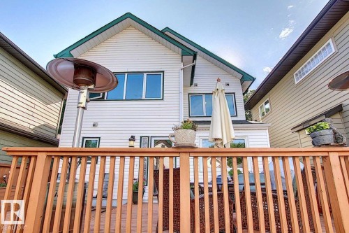 The property features a wooden deck with railing, providing an outdoor living space - 11126 52 Street Nw, Edmonton, AB - Outdoor With Exterior