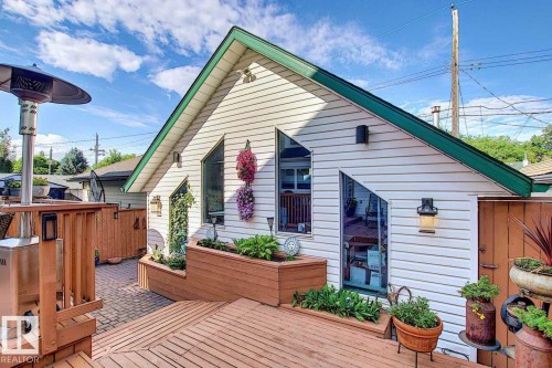 The property features a private deck area with wooden fencing and built-in planters - 11126 52 Street Nw, Edmonton, AB - Outdoor With Deck Patio Veranda With Exterior