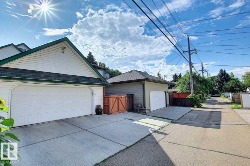The property features a white paneled garage door and a concrete driveway - 11126 52 Street Nw, Edmonton, AB - Outdoor With Exterior