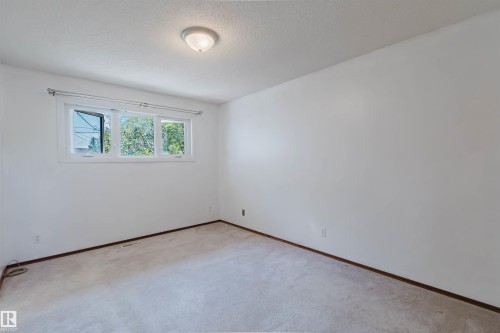 Bedroom featuring light-colored carpeting, white walls, and a multi-pane window - 11115 39A Avenue Nw, Edmonton, AB - Indoor Photo Showing Other Room