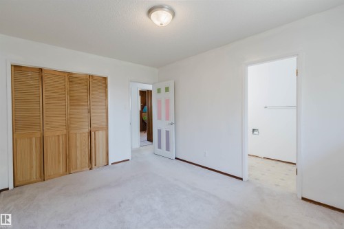 Spacious room with light-toned carpeting and white walls - 11115 39A Avenue Nw, Edmonton, AB - Indoor Photo Showing Other Room