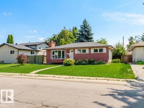 Ranch-style residence featuring a red siding exterior and a prominent bay window - 11115 39A Avenue Nw, Edmonton, AB - Outdoor