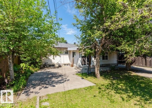 Expansive concrete patio area with a green lawn surround - 11115 39A Avenue Nw, Edmonton, AB - Outdoor