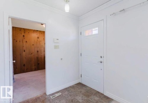 Entryway featuring a white door with upper window panes, textured tile flooring, and crisp white walls - 11115 39A Avenue Nw, Edmonton, AB - Indoor Photo Showing Other Room