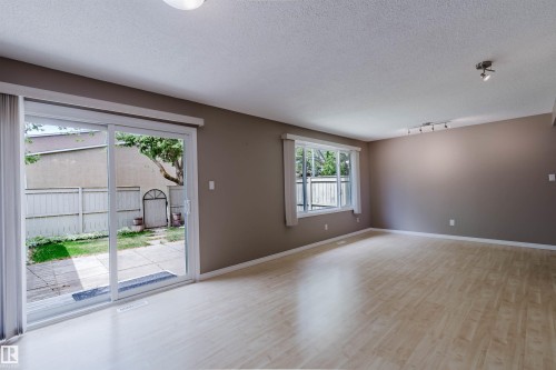 Spacious room featuring light wood-finish flooring, neutral wall tones, and recessed ceiling lighting - 134 Callingwood Place Nw, Edmonton, AB - Indoor Photo Showing Other Room