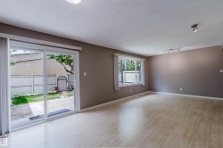 Spacious room featuring light wood-finish flooring, neutral wall tones, and recessed ceiling lighting - 