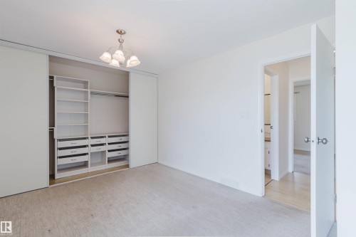 Built-in closet organization system with shelving and drawers - 134 Callingwood Place Nw, Edmonton, AB - Indoor Photo Showing Other Room