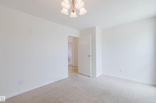Neutral tone walls with light-colored carpeting - 134 Callingwood Place Nw, Edmonton, AB - Indoor Photo Showing Other Room