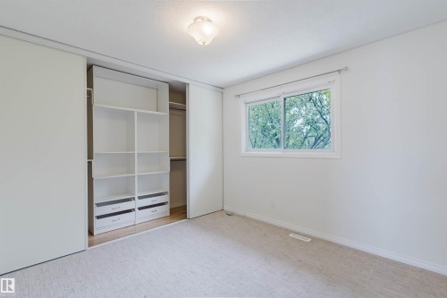Room with light beige carpeting and white painted walls - 134 Callingwood Place Nw, Edmonton, AB - Indoor Photo Showing Other Room