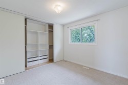 Room with light beige carpeting and white painted walls - 