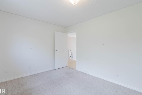 Room with light-colored carpeting, white baseboards, and a white ceiling - 134 Callingwood Place Nw, Edmonton, AB - Indoor Photo Showing Other Room