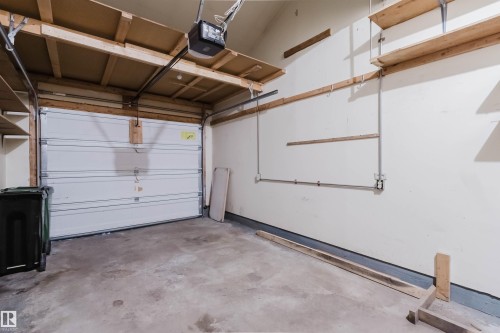 Attached garage featuring a white overhead door and concrete flooring - 134 Callingwood Place Nw, Edmonton, AB - Indoor Photo Showing Garage
