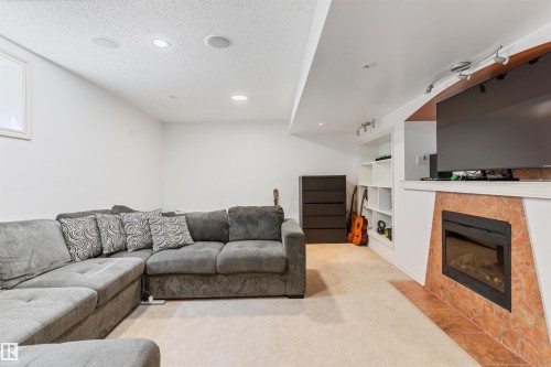 1075 Mckinney Green Nw, Edmonton, AB - Indoor Photo Showing Living Room With Fireplace