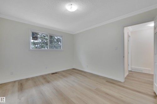Light-filled room featuring wood-finish flooring and a white trim package - 3607 53 Street, Wetaskiwin, AB - Indoor Photo Showing Other Room