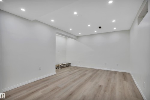 Spacious room featuring light wood-finish flooring, recessed ceiling lighting, white baseboards, and neutral wall tones - 3607 53 Street, Wetaskiwin, AB - Indoor Photo Showing Other Room