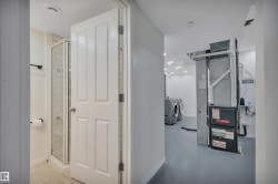 Utility area featuring a furnace system, water heater, and washer/dryer hookups - 