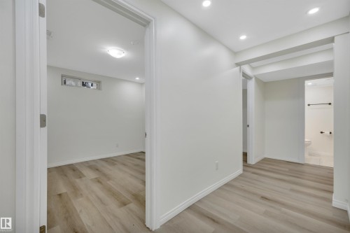 Interior space featuring wood-finish flooring, recessed lighting, and crisp white walls - 3607 53 Street, Wetaskiwin, AB - Indoor Photo Showing Other Room