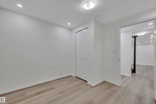 Room featuring wood-finish flooring, recessed lighting, and a bi-fold closet door - 3607 53 Street, Wetaskiwin, AB - Indoor Photo Showing Other Room