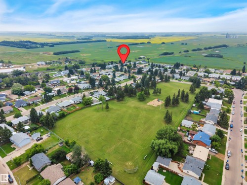 Aerial perspective showcasing a residential neighborhood with a central green space - 3607 53 Street, Wetaskiwin, AB - Outdoor With View