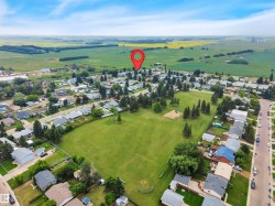 Aerial perspective showcasing a residential neighborhood with a central green space - 