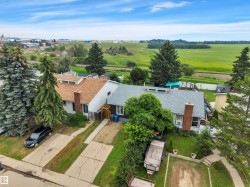 Two residential properties featuring shingled roofs and established landscaping - 