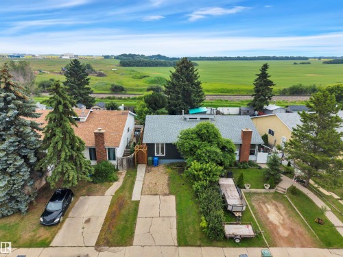 Single-story residence featuring a gray shingle roof and a brick chimney - 3607 53 Street, Wetaskiwin, AB - Outdoor With View