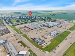 Aerial perspective showcasing multiple commercial buildings and an expansive parking lot - 