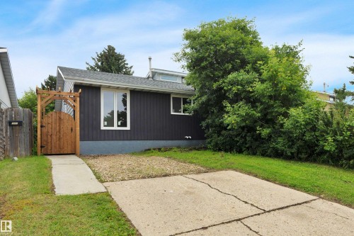 Contemporary dark siding exterior with white-framed windows - 3607 53 Street, Wetaskiwin, AB - Outdoor