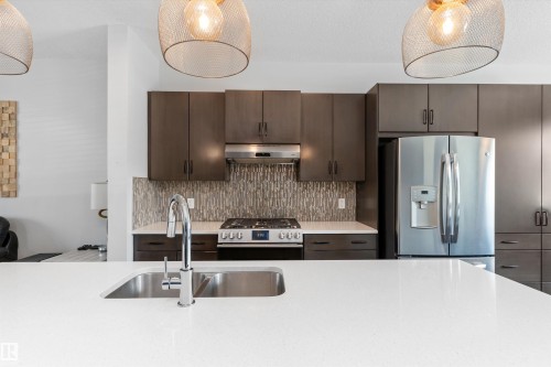 Modern kitchen with white countertops and stainless steel appliances - 3456 Cutler Crescent Sw, Edmonton, AB - Indoor Photo Showing Kitchen With Double Sink With Upgraded Kitchen