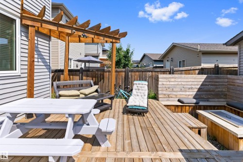 Multi-level wood deck featuring a pergola, built-in benches, and a built-in fire pit - 3456 Cutler Crescent Sw, Edmonton, AB - Outdoor With Deck Patio Veranda With Exterior