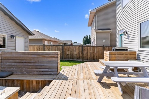 Multi-level wooden deck with built-in seating, privacy screening, and a dedicated grill enclosure - 3456 Cutler Crescent Sw, Edmonton, AB - Outdoor With Deck Patio Veranda With Exterior