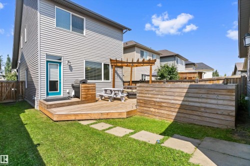 Expansive outdoor living space featuring a wooden deck, a built-in privacy screen, a wooden pergola, and a stone walkway - 3456 Cutler Crescent Sw, Edmonton, AB - Outdoor With Deck Patio Veranda With Exterior