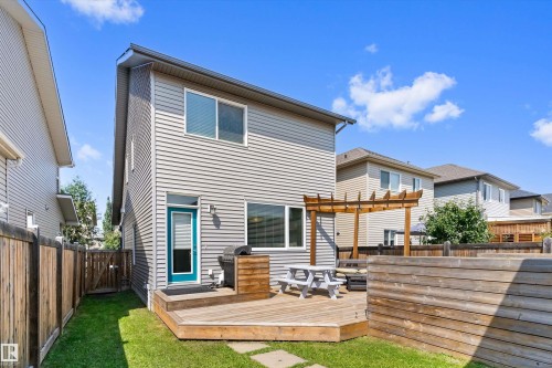 Spacious backyard featuring a wooden deck, wood-slat privacy fence, and a pergola structure - 3456 Cutler Crescent Sw, Edmonton, AB - Outdoor With Deck Patio Veranda With Exterior