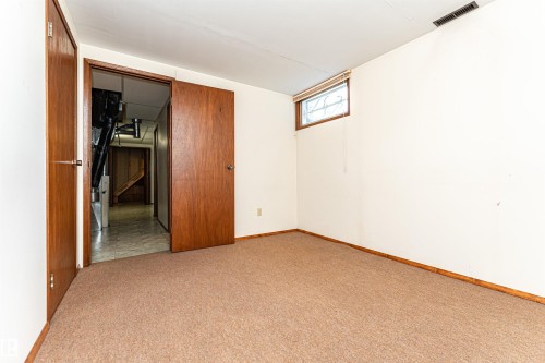 Carpeted room with a small window featuring a blind - 4812 105B Street Nw, Edmonton, AB - Indoor Photo Showing Other Room