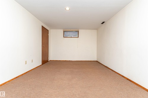 Open room featuring neutral-toned carpet, white walls, and a recessed ceiling light - 4812 105B Street Nw, Edmonton, AB - Indoor Photo Showing Other Room