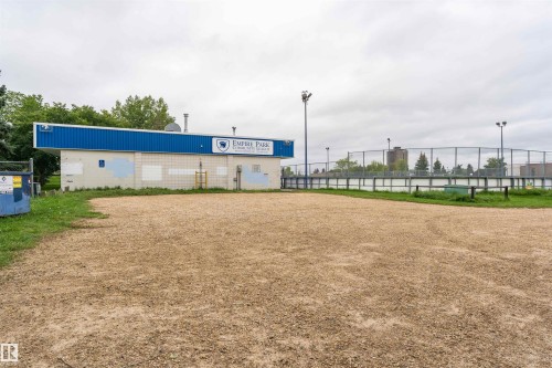 Gravel lot fronting a community league building and fenced outdoor rink - 4812 105B Street Nw, Edmonton, AB - Outdoor