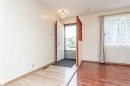 Entryway with varying wood-finish flooring and a decorative chandelier - 4812 105B Street Nw, Edmonton, AB  - Indoor Photo Showing Other Room 
