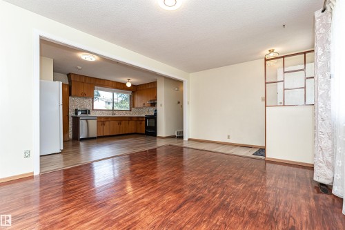 Hardwood-finish flooring extending into the living area - 4812 105B Street Nw, Edmonton, AB - Indoor