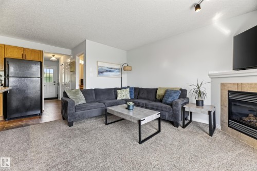 #6 12104 16 Av Sw, Edmonton, AB - Indoor Photo Showing Living Room With Fireplace